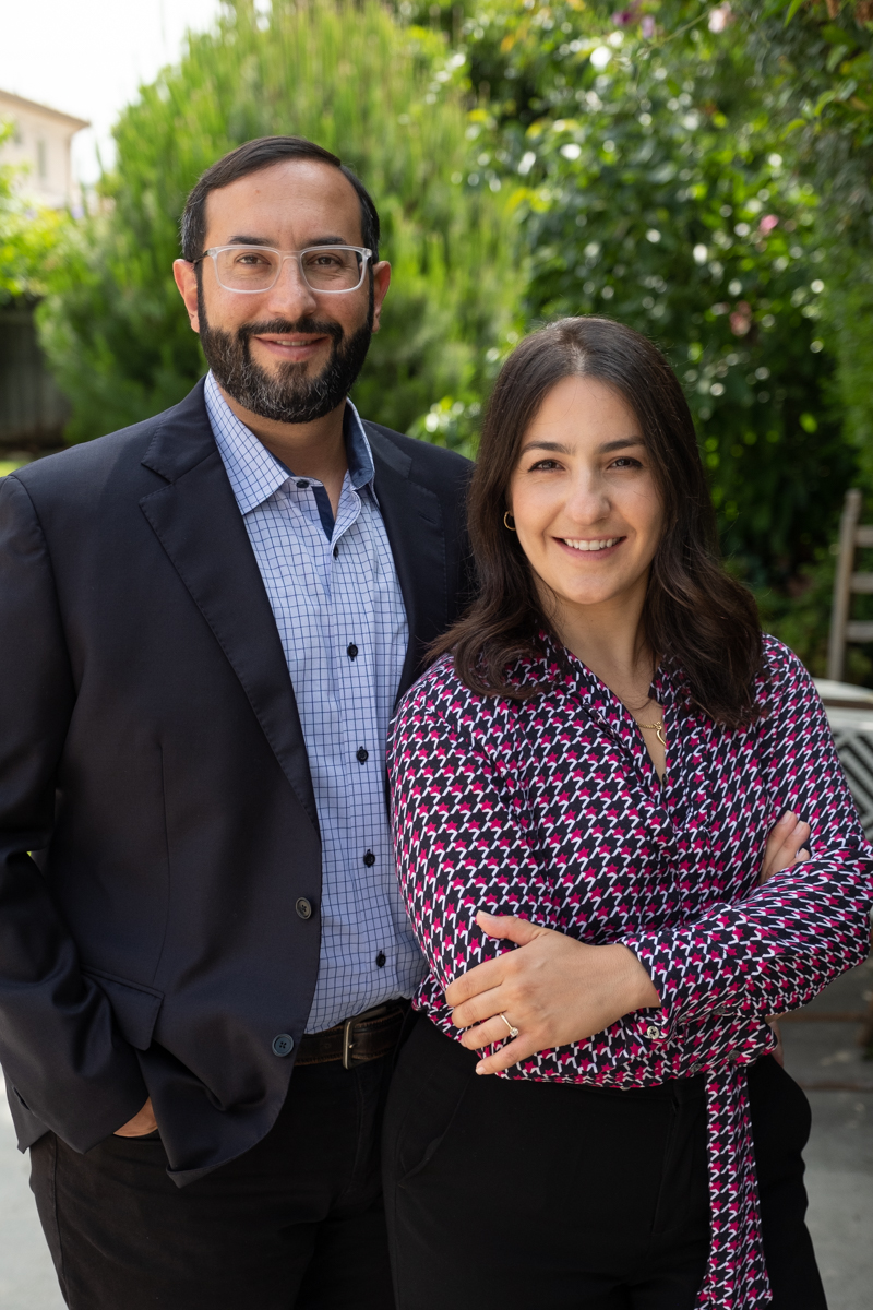 "Pile of Real Estate pamphlets on desk with management and property office sign in background"